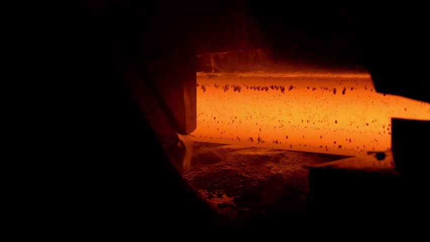 Iron foundry. Continuous casting machine. Production of steel billets. Continuous casting machine with blow torch working. hot steel on conveyor in steel mill.