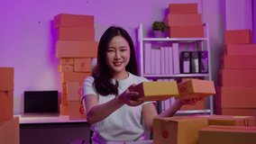 FPV view of online seller is live streaming broadcast for selling new products in parcel boxes and receiving the orders from customer via smartphone and laptop on shopping online application.