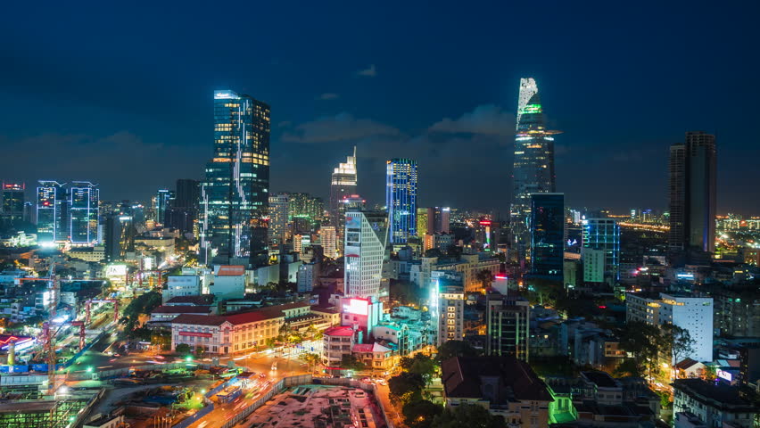 Timelapse view of Ho Chi Minh City (Saigon), Vietnam, showing landmark buildings and traffic in the financial district at night.