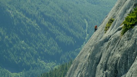 Aerial of Caucasian climbing team expedition on the rocky extreme wall of Mount Habrich in Squamish Valley Canada RED WEAPON