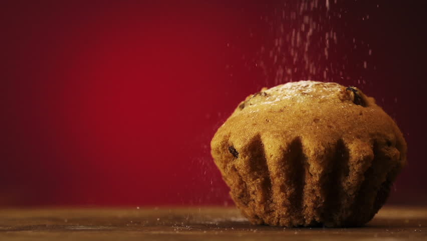 Muffin cake with white powdered sugar on red