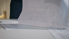 Focused architect drawing blueprint working in engineering office close up. Professional constructor looking at architectural plan on desk checking information at laptop. Busy man planning building. - Powered by Shutterstock - Get 15% off with code: PIKWIZARD15
