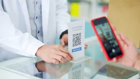 Medical pharmacy and contactless payment concept. Asian woman patient customer using mobile phone scan QR code on counter making online baking payment buying medicine and supplements in drugstore. - Powered by Shutterstock - Get 15% off with code: PIKWIZARD15