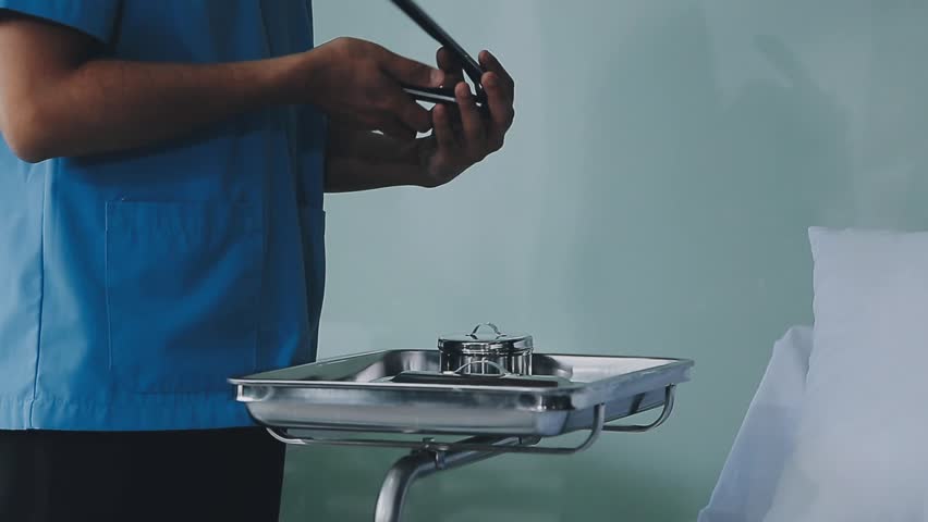 Surgical instruments in the operating room, the surgeon's assistant arranges them on a sterile takani. The concept of medecine, surgery, sterile area. Plastic surgery. Selective focus.