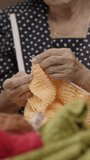 Elderly woman and daughter knitting together for protect dementia and memory loss. Vertical video.