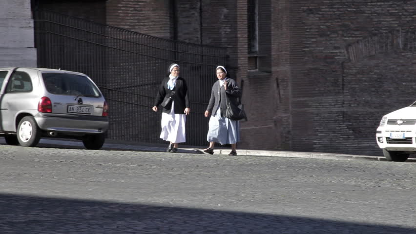 ROME - CIRCA MAY 2012: Two nuns cross a quiet street in Rome.