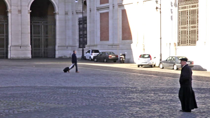 ROME - CIRCA MAY 2012: Man walks across Piazza San Giovanni