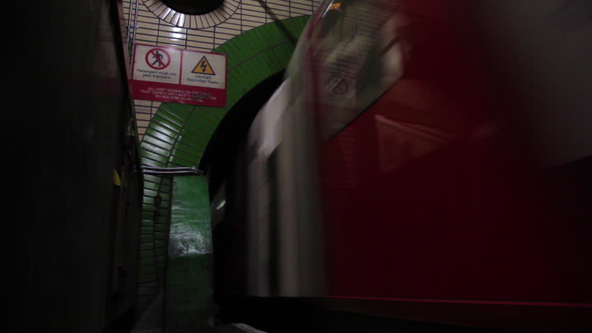 LONDON - OCTOBER 7, 2011: The underground tube speeding through and out of the