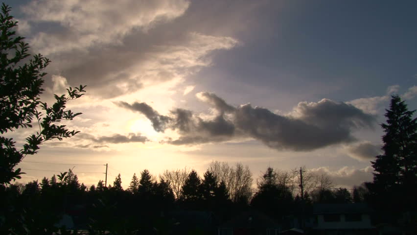Time lapse during sunset with clouds dispersing around sun in Portland