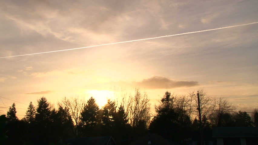Time lapse during sunset over tree line in Portland neighborhood.