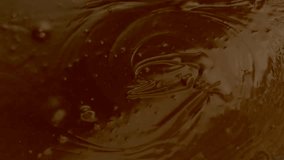 Super Slow Motion: Almonds Splashing into Hot Chocolate in 4K Ultra HD Resolution	