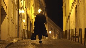 A sad man is walking go away on street at night, carrying a bag - Powered by Shutterstock - Get 15% off with code: PIKWIZARD15