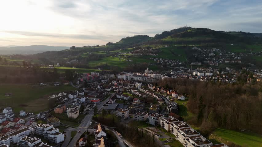 Aerial view of swiss small Town with hill and neighborhood at sunset time. Wald City, Switzerland. Wide shot.