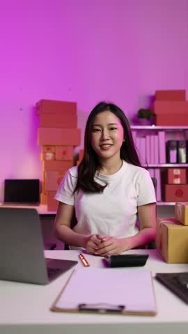 Video footage of a woman doing a live broadcast of online sales at home. Device screen