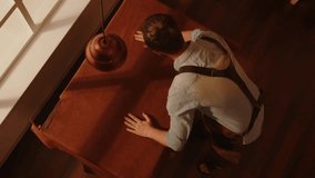 Shoemaker rolls out and inspects leather material on the table in the workshop top view. - Powered by Shutterstock - Get 15% off with code: PIKWIZARD15