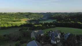 Picturesque and rural village houses in French countryside, Correze in Nouvelle Aquitaine. Aerial forward and sky for copy space