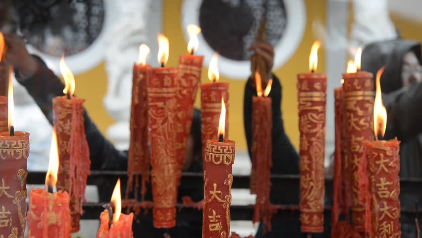 Ningbo, CHINA - Feb 13, 2013: People light candles and incense in Xuedou Temple