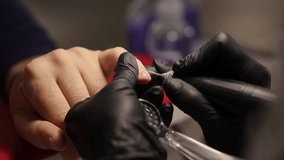 Men's manicure. Male hand undergoing a manicure procedure. The master does a man's manicure. A manicurist files a man's nails in a salon. Hygiene and hand care for men. Men's manicure design. 