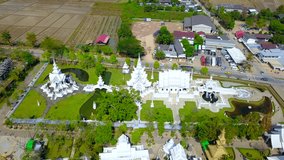 4K video resolution aerial view from drone flying through background,Top view from drone flying over beautiful Thai Temple at Northern Thailand.