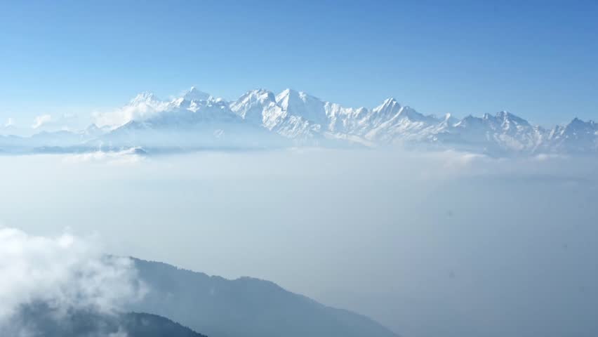 Time lapse of clouds moving into the vast himalayan mountin valley in front of the mountains of Ganesh Himal. Nepal