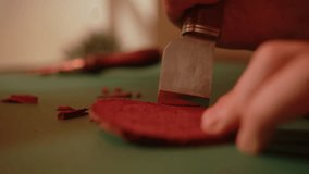 Artisan shoemaker processes piece of leather with saddlery knife. Craftsman making handmade shoes. - Powered by Shutterstock - Get 15% off with code: PIKWIZARD15