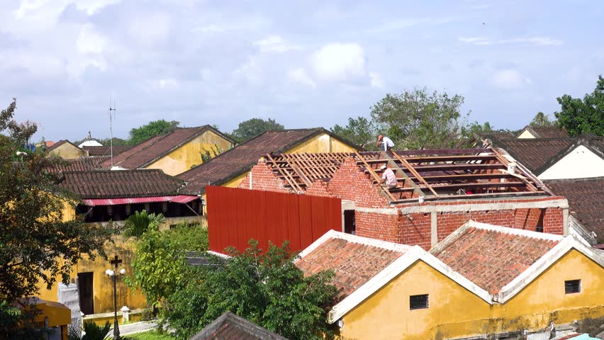 Quang Nam, Vietnam - NOV 2017: Unidentified worker working on the rooftop in Hoi An city. Hoian is a city in Vietnam