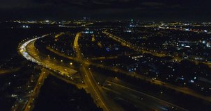 Aerial night illuminated highway of rolling Madrid city and districts. Lateral movement - 004