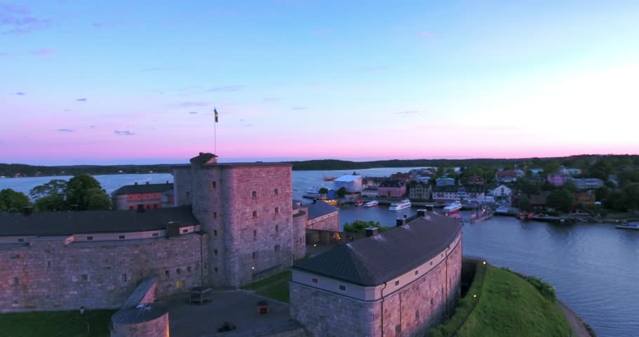 Aerial: The Twilight Sky Softens Around The Rugged Grandeur Of The Historic Fortress, Standing Proudly Amidst Tranquil Waters, Echoing Tales Of Yore - Stockholm, Sweden