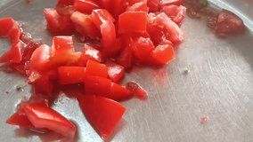Culinary Close Up: Slicing Ripe Tomatoes Replace with specifics,High res video of juicy red tomatoes being sliced on stainless steel. Perfect for cooking content  food presentations.