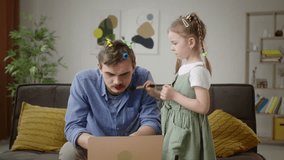 Multitasking Dad Gets Styled by Daughter While Working from Home