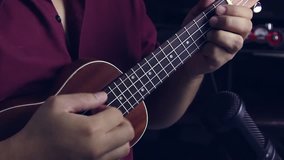 A man is playing ukulele in close up view, Footage Video