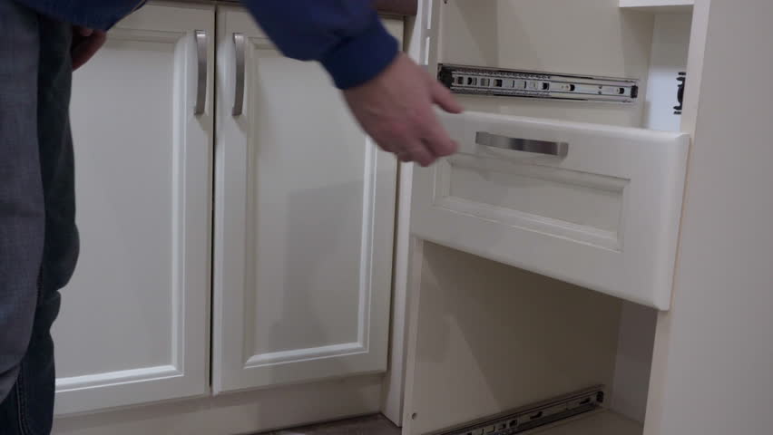 pull out the kitchen drawer, the carpenter pulls out the drawer from the sliding telescopic slides