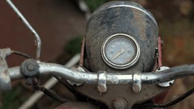 Old motorcycle in the dust. Red retro moto. Defective motorcycle, needs repair. A dirty rural gasoline motorcycle, next to it in the yard around the mess - Powered by Shutterstock - Get 15% off with code: PIKWIZARD15