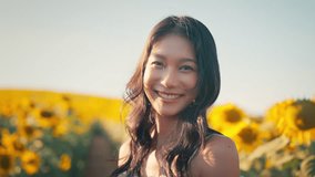 Happy asian woman smiling in sunflower field outdoors, Cheerful Young female looking at the camera feeling free in blooming garden in summer day. - Powered by Shutterstock - Get 15% off with code: PIKWIZARD15