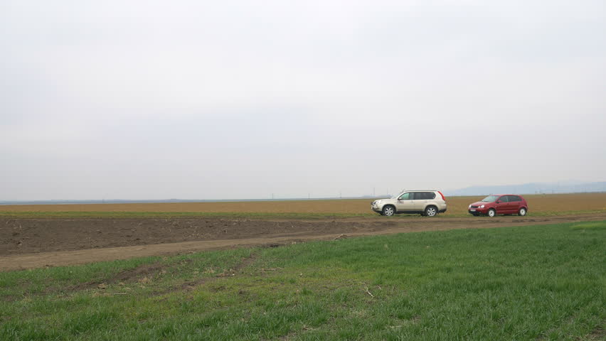 Cars parked on a field in the spring time