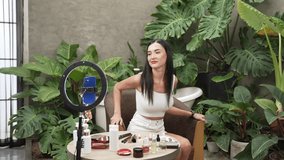 Beauty content creator start live stream or record on natural beauty and cosmetic tutorial at green plant garden video. Beauty blogger show how to apply cosmetic to social medial audience. Blithe