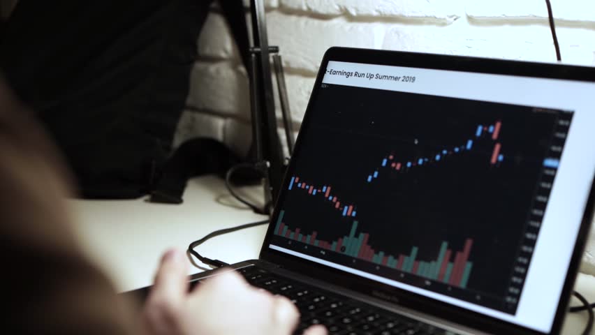 Trading stocks online. Man working on laptop in the office Mykyta