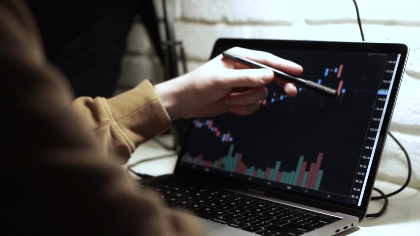 Trading stocks online. Man working on laptop in the office Mykyta