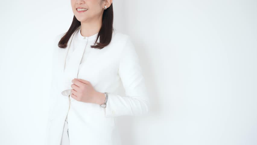 A refreshing middle-aged woman wearing a white suit.