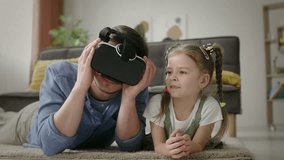 Delighted Father Helps Daughter with Virtual Reality Headset During Playtime