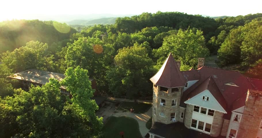 Aerial view pulling away from the Graceland Inn and Robert C. Byrd Center for Hospitality & Tourism on the campus of Davis & Elkins College in Elkins, WV. Royalty-Free Stock Footage #34661911