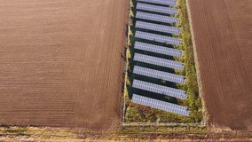Solar panels farm in the middle of a plowed field