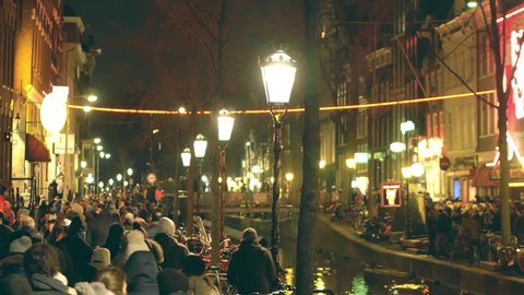 AMSTERDAM, NETHERLANDS - DECEMBER 27, 2017. Crowded embankment of the famous red light district De Wallen