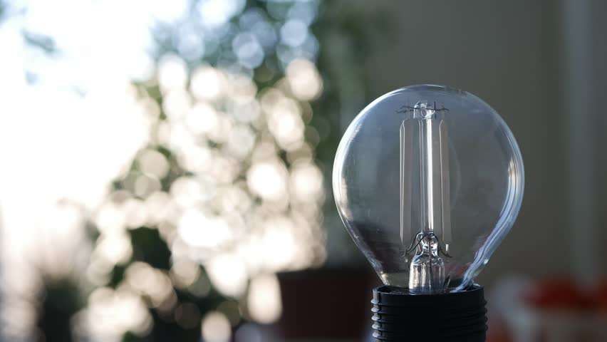 Shooting with a Led Light Bulb Lighting On a Room. Low Energy Consumption Concept with Led Lighting Technology. Powering Off the Light in a Room. Royalty-Free Stock Footage #3466267319