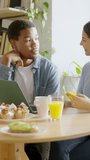 Multiethnic couple about to shopping online during breakfast at home