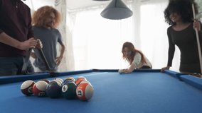 Happy multiethnic friends playing pool together at home - Powered by Shutterstock - Get 15% off with code: PIKWIZARD15