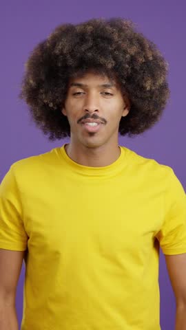 Stylish african man kissing on purple background