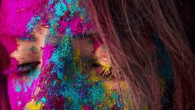 Female hazel brown eyes with colourful makeup open and close in slow motion closeup. Face covered with multi colorful powders. Celebrating Holi Festival. Creative abstract colorful splash art make-up. - Powered by Shutterstock - Get 15% off with code: PIKWIZARD15