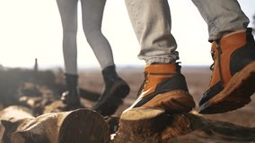 hiker group walk in the forest park. close-up hiker feet walking on a fallen tree log. travel adventure teamwork concept. tourist feet boots sneakers walks on fallen tree in park lifestyle - Powered by Shutterstock - Get 15% off with code: PIKWIZARD15