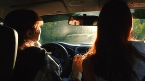 Two happy redhead young female friends dancing having fun driving car road trip closeup back view. Smiling woman relaxing dance music radio automobile journey adventure escape at bright sun light - Powered by Shutterstock - Get 15% off with code: PIKWIZARD15